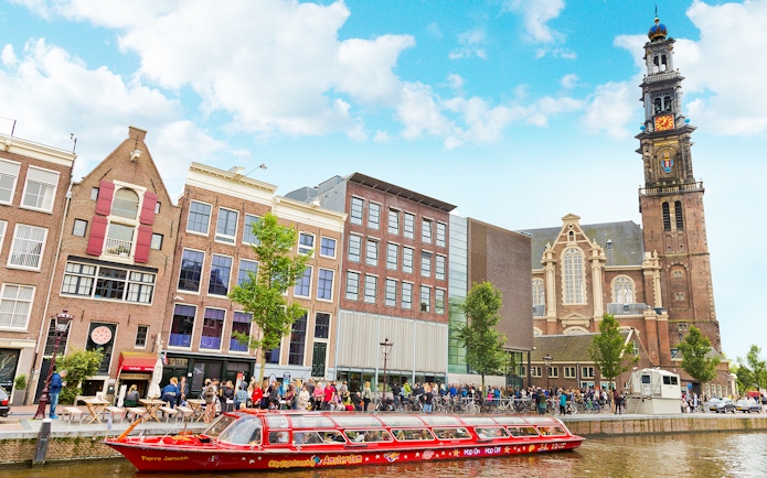 Hop-on hop-off boat near Westerkerk church in Amsterdam.