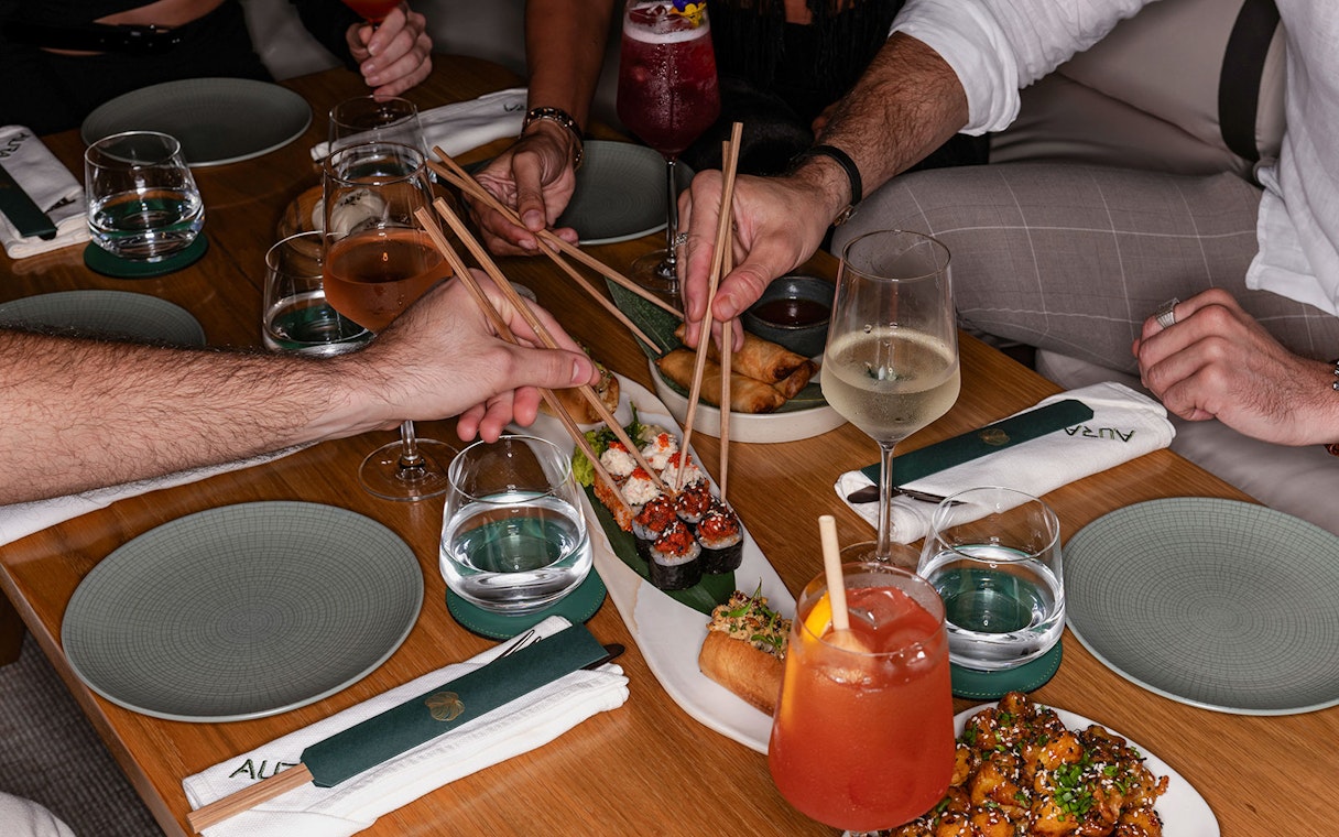 Dining experience with sushi and drinks at Aura Sky Pool.