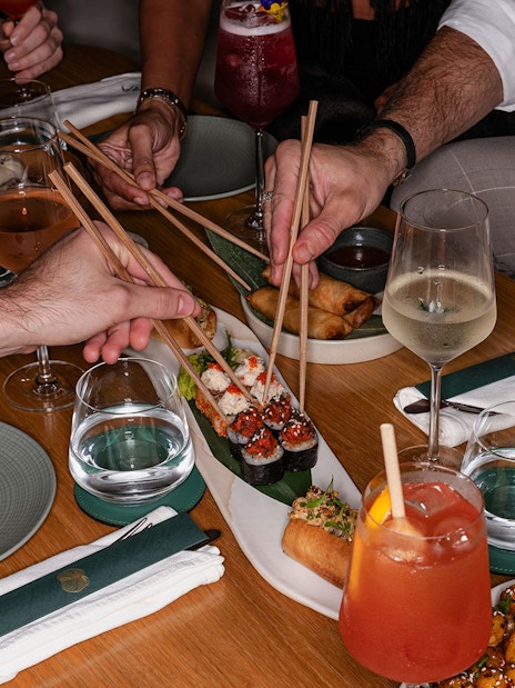 Dining experience with sushi and drinks at Aura Sky Pool.