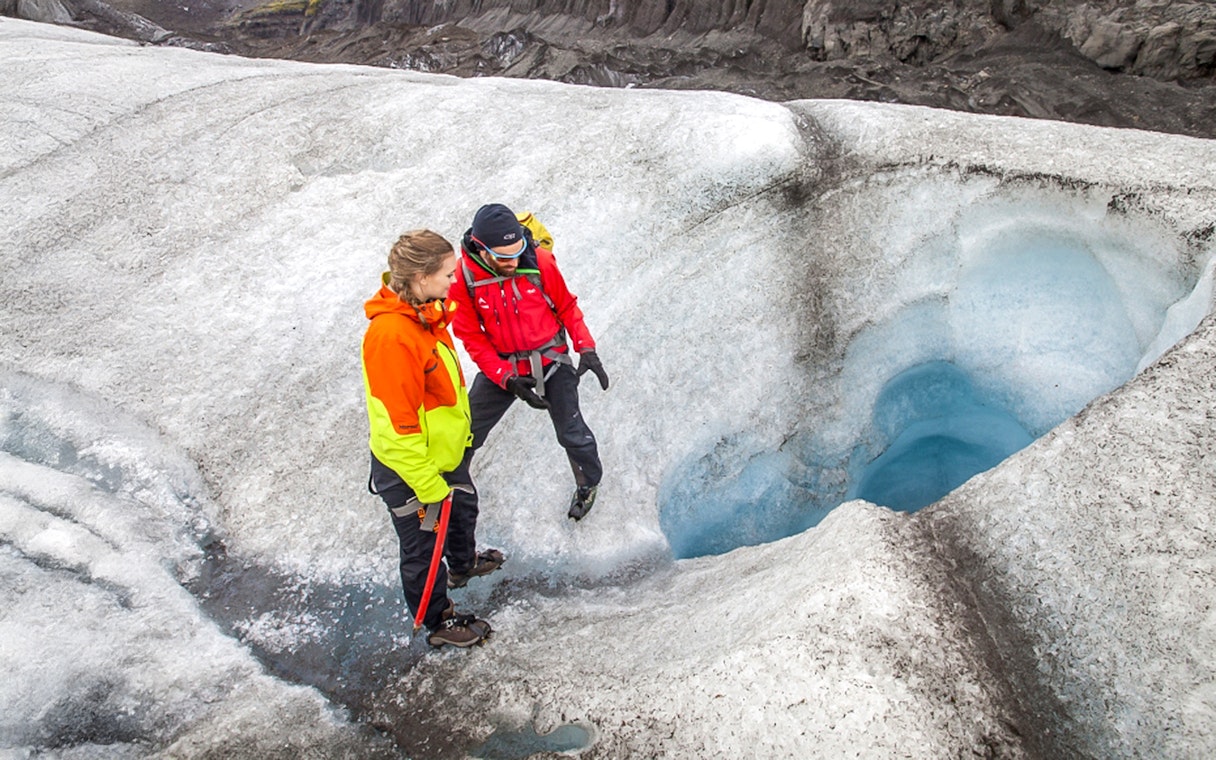 Tour guide explaining glacier features to guests during Blue Ice Experience at Skaftafell.