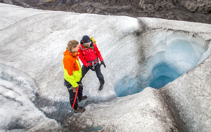 Tour guide explaining glacier features to guests during Blue Ice Experience at Skaftafell.