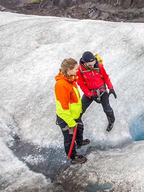 Tour guide explaining glacier features to guests during Blue Ice Experience at Skaftafell.