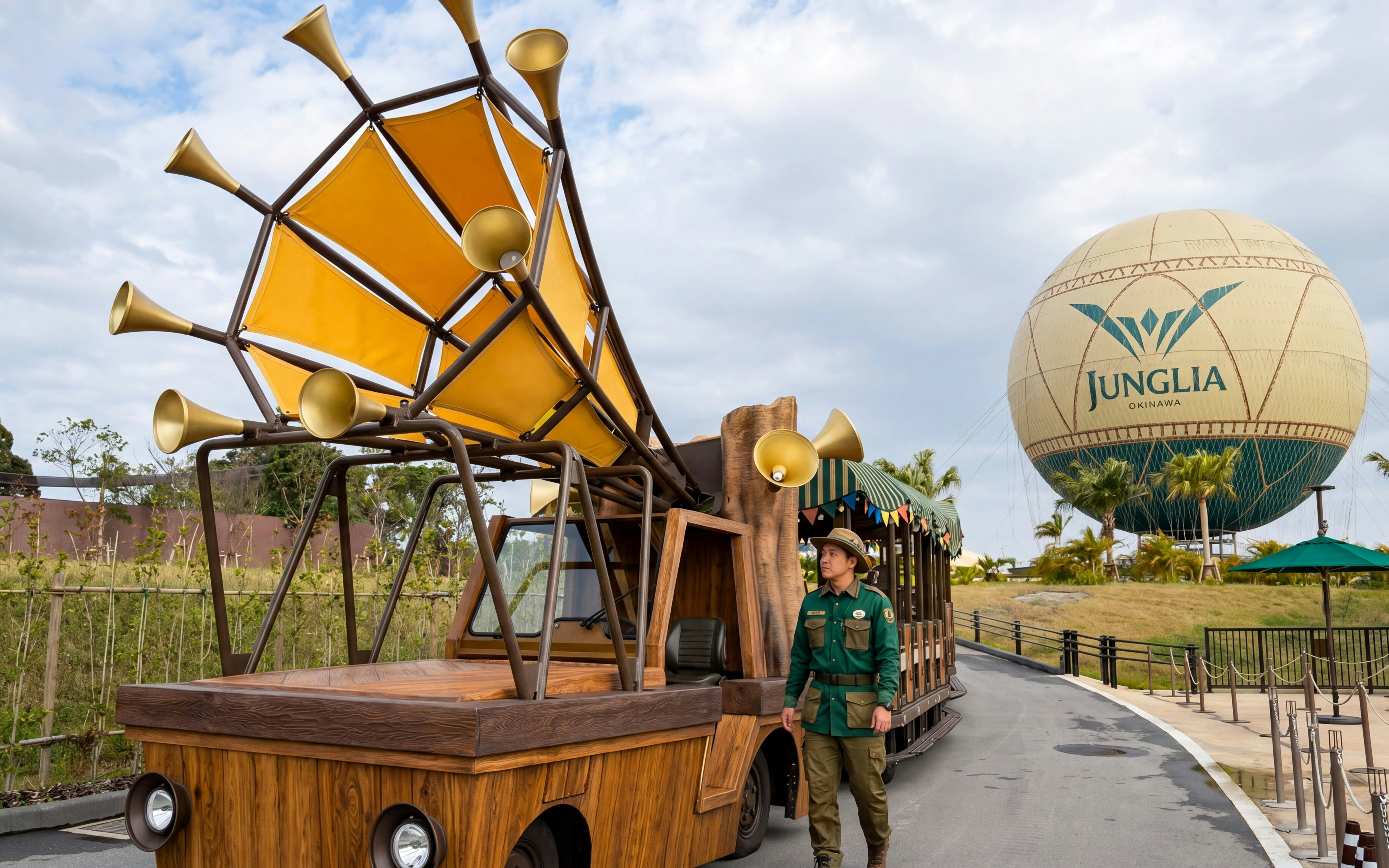 Jungalia Okinawa Tam Tam Tram with guide near large balloon structure.