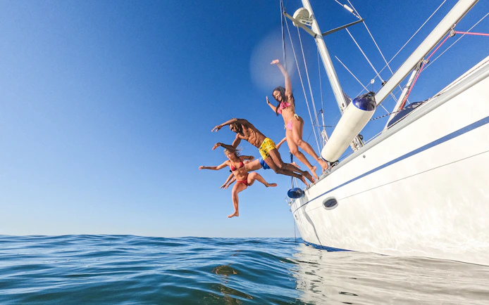 People jumping off a yacht into the sea on a Langkawi cruise.
