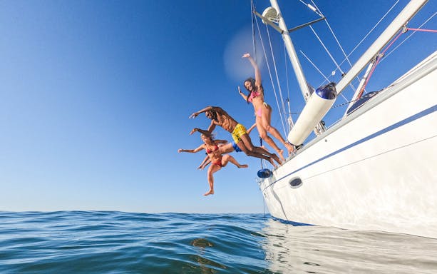 People jumping off a yacht into the sea on a Langkawi cruise.