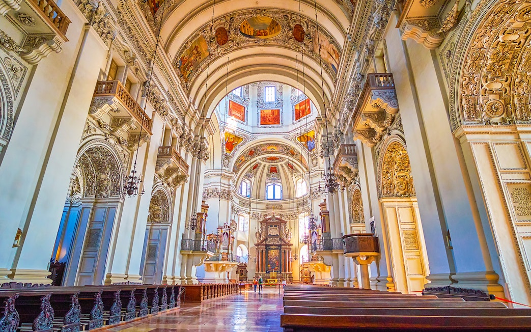 Salzburg Cathedral interior with ornate arches and detailed frescoes, part of Salzburg tour.