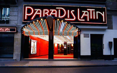 Paradis Latin entrance with illuminated marquee in Paris, France.