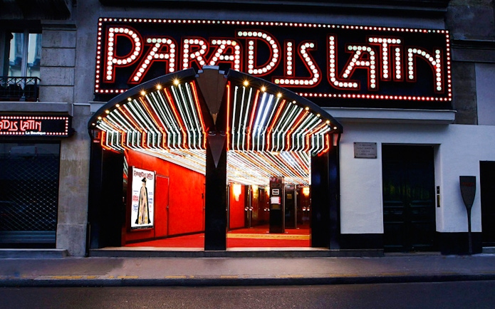Paradis Latin entrance with illuminated marquee in Paris, France.