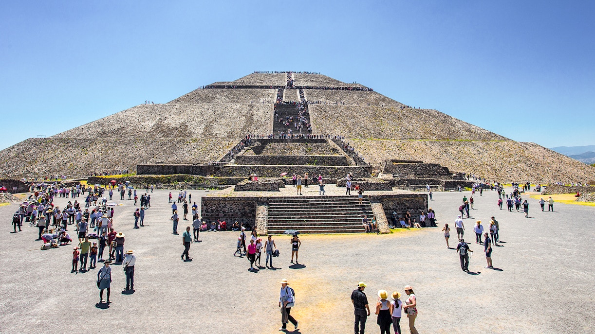 Sun Pyramid at Teotihuacan with tourists exploring the ancient archaeological site.