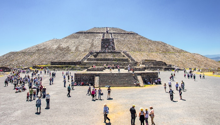 Sun Pyramid at Teotihuacan with tourists exploring the ancient archaeological site.