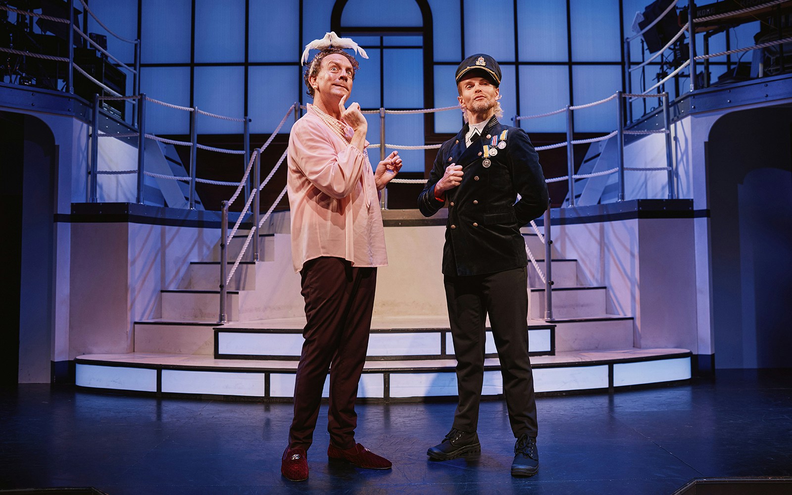 Actors performing on stage in a scene from the musical "Titanique.