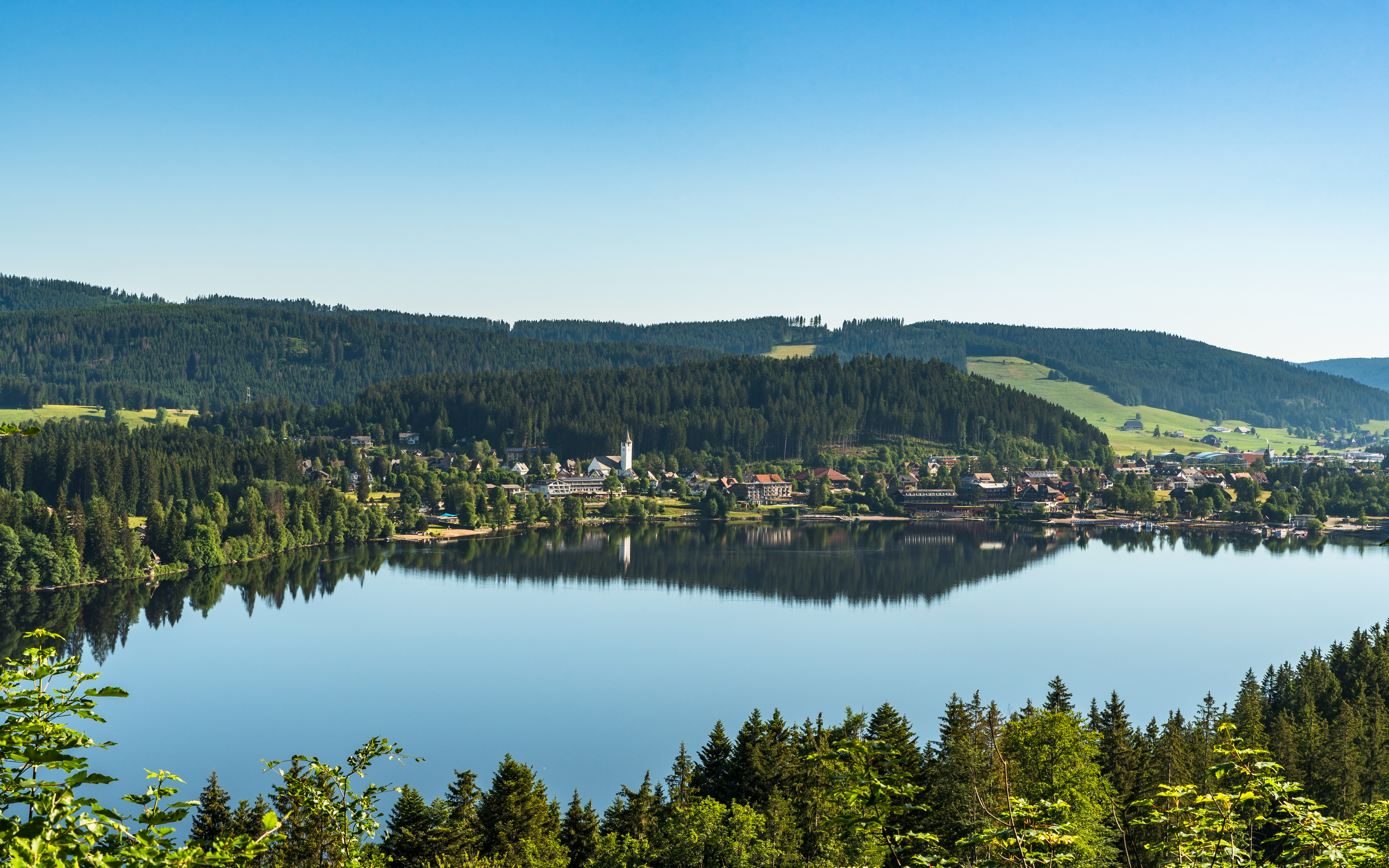 Aerial view of Lake Titisee with surrounding forest and village in the Black Forest, Germany.