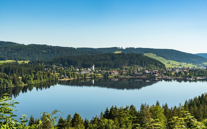 Aerial view of Lake Titisee with surrounding forest and village in the Black Forest, Germany.
