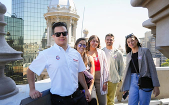 Tourists with guide on rooftop near Metropolitan Cathedral of Santiago, Chile.