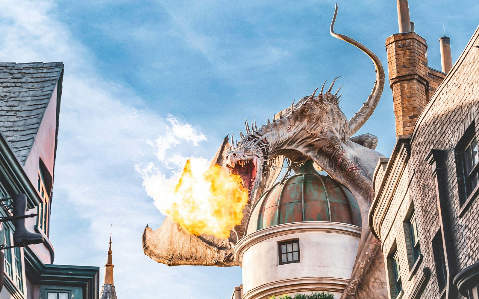 Dragon breathing fire atop a building at Universal Studios Orlando Resort.