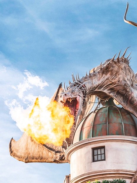 Dragon breathing fire atop a building at Universal Studios Orlando Resort.