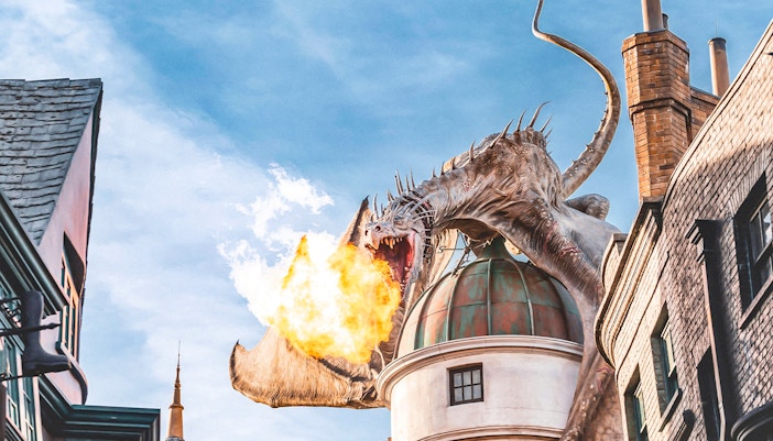 Dragon breathing fire atop a building at Universal Studios Orlando Resort.