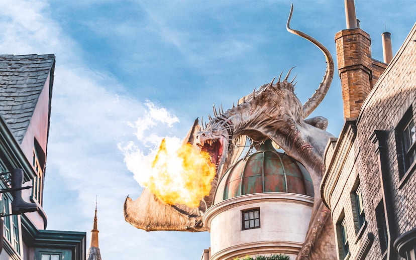 Dragon breathing fire atop a building at Universal Studios Orlando Resort.