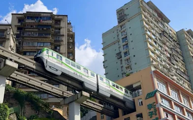 Monorail passing through residential building at Liziba Station, Chongqing Rail Transit Line 2, China.