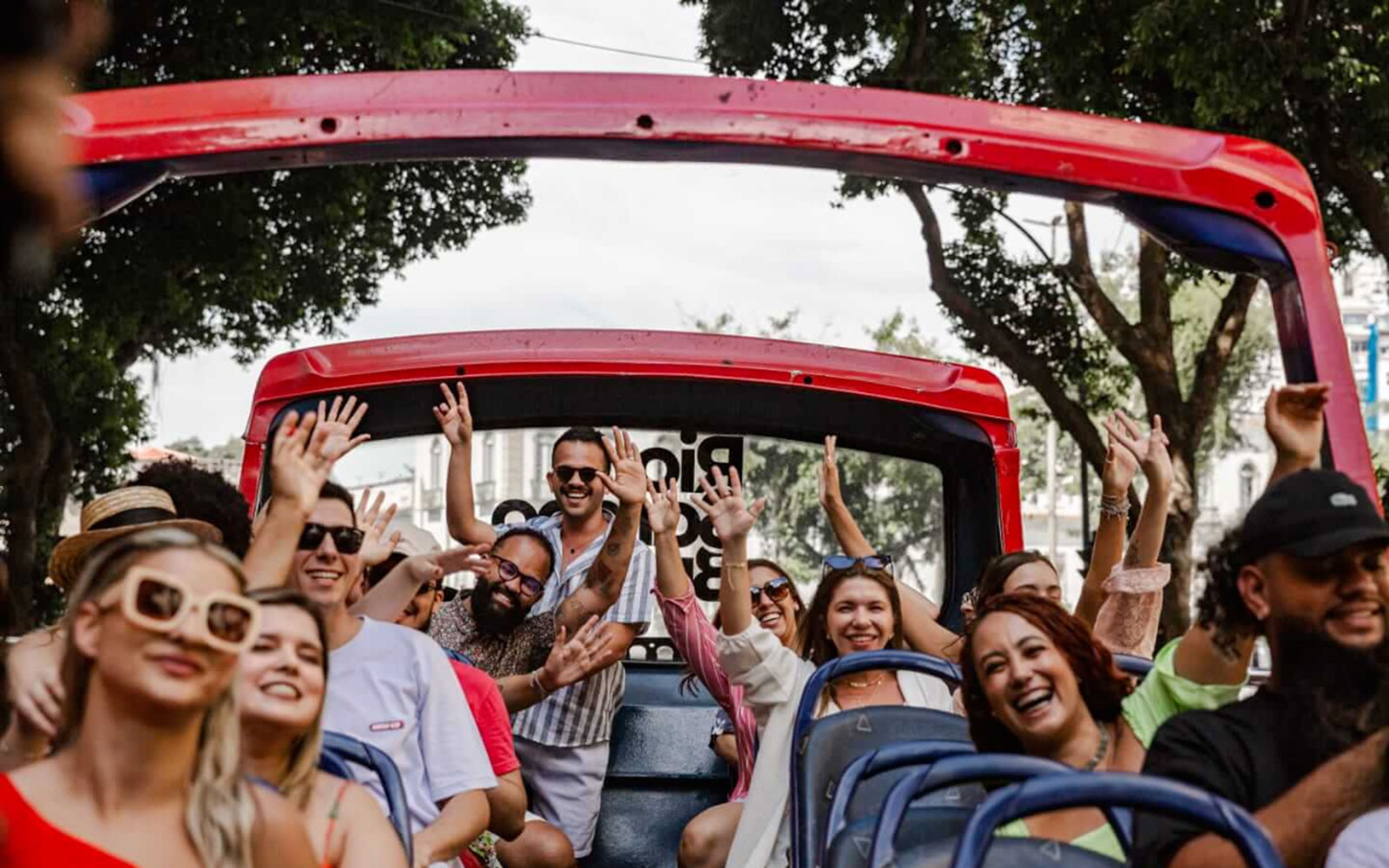 Tourists enjoying a ride on a Rio de Janeiro hop-on hop-off bus.