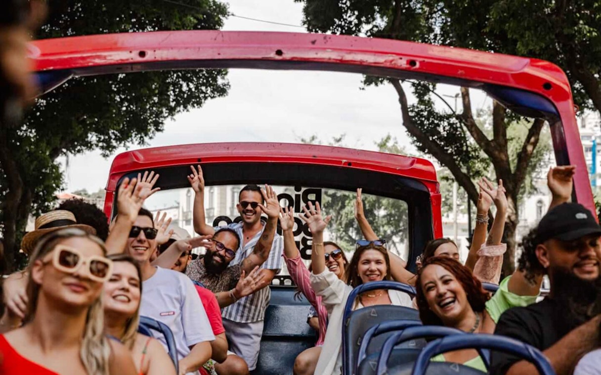 Tourists enjoying a ride on a Rio de Janeiro hop-on hop-off bus.