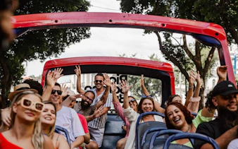 Tourists enjoying a ride on a Rio de Janeiro hop-on hop-off bus.