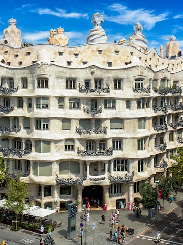 La Pedrera - Casa Milà in Barcelona, showcasing its unique stone facade and rooftop sculptures.