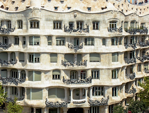 La Pedrera - Casa Milà in Barcelona, showcasing its unique stone facade and rooftop sculptures.