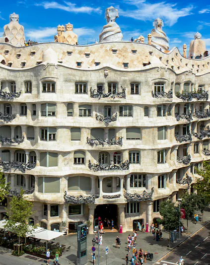 La Pedrera - Casa Milà in Barcelona, showcasing its unique stone facade and rooftop sculptures.