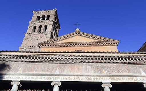 Ancient Roman church facade with bell tower in Rome, part of Velabrum Walking Tour.