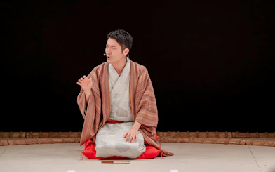 Sumo wrestler in traditional attire during training at Sumo Hall Hirakuzu, Osaka.
