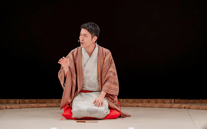 Sumo wrestler in traditional attire during training at Sumo Hall Hirakuzu, Osaka.