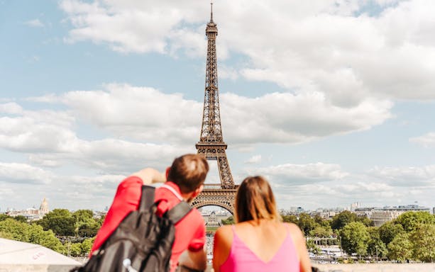 Tourists viewing the Eiffel Tower in Paris, France.