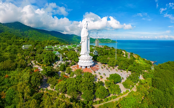 Lady Buddha statue on Son Tra Peninsula, Da Nang, Vietnam, surrounded by lush greenery and ocean views.