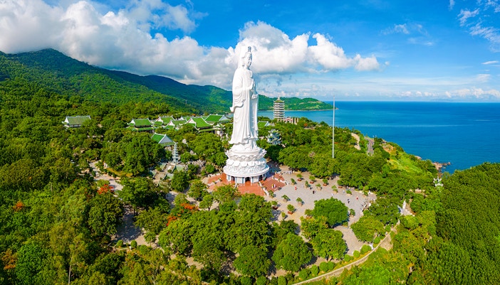 Lady Buddha statue on Son Tra Peninsula, Da Nang, Vietnam, surrounded by lush greenery and ocean views.