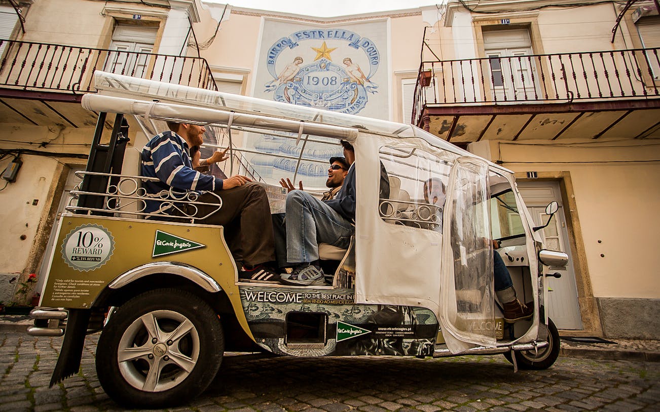 Private electric tuk tuk on cobblestone street during half-day guided sightseeing tour.