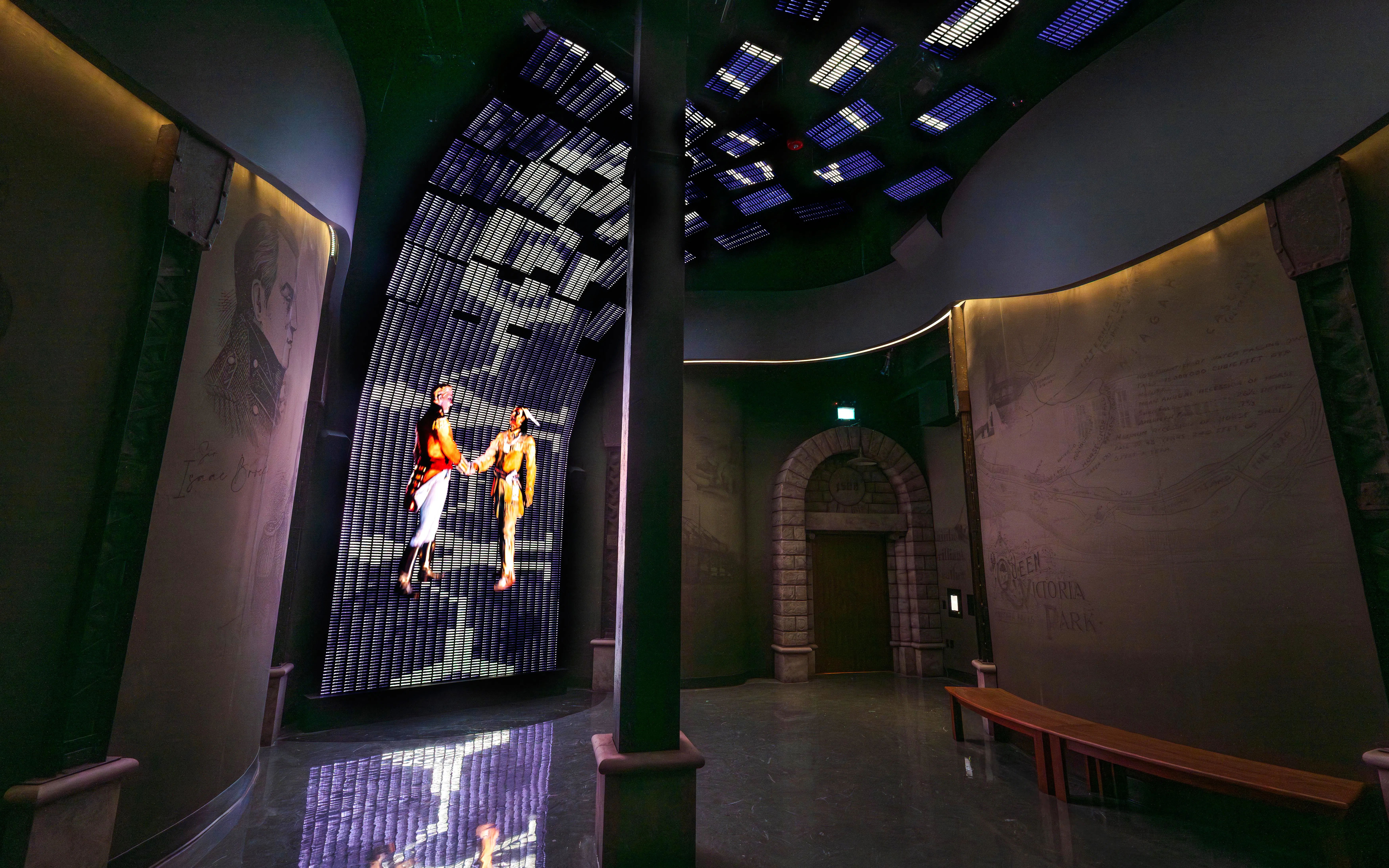 Interactive exhibit at Niagara Takes Flight, Canada, featuring historical figures on a digital display.