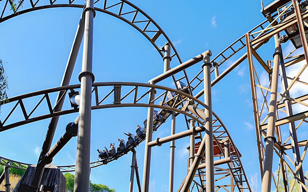 Roller coaster on TNT Mine Train ride at Parque de Atracciones de Madrid.