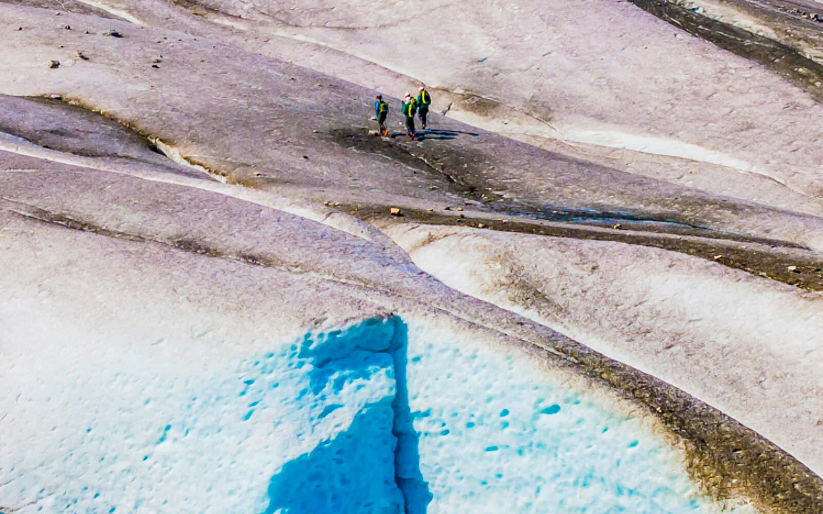 Hikers exploring a glacier during the Norris Adventure tour.