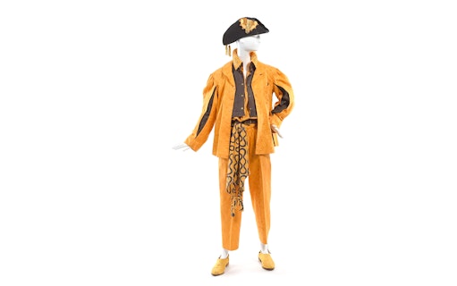 Mannequin in orange Vivienne Westwood outfit with hat at NGV exhibition.