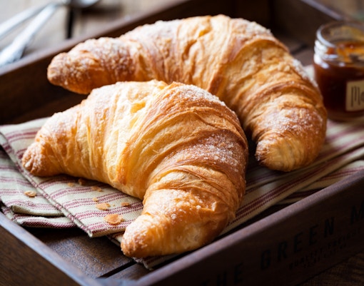 Freshly baked croissant on a wooden table