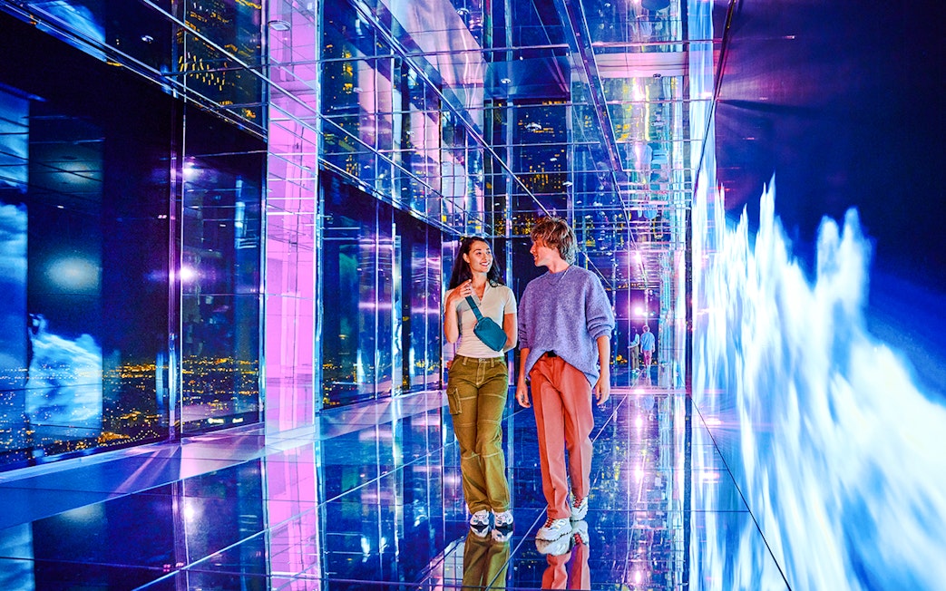 Guests exploring mirrored hallway at Summit One Vanderbilt, New York City.