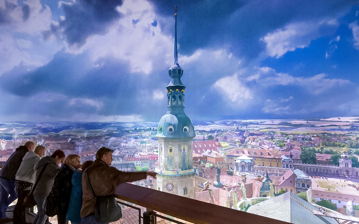 Visitors viewing panoramic cityscape at Panometer Dresden.