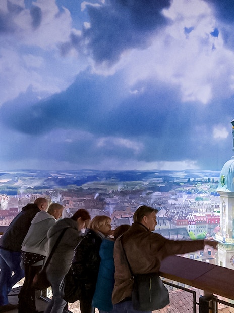 Visitors viewing panoramic cityscape at Panometer Dresden.