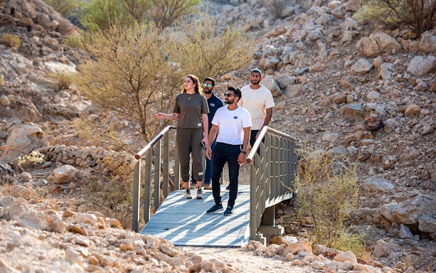 Visitors walking on a bridge at Mleiha Archaeology Centre during the Sounds of the Past Tour.