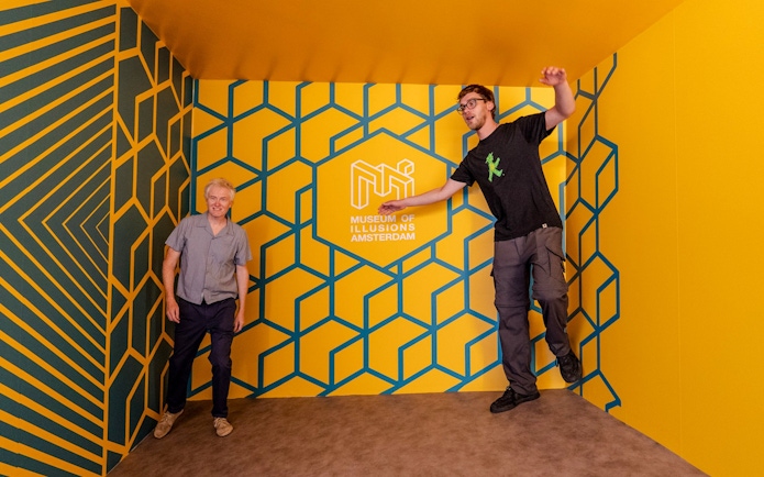Guests interacting with optical illusions at the Museum of Illusions Amsterdam.