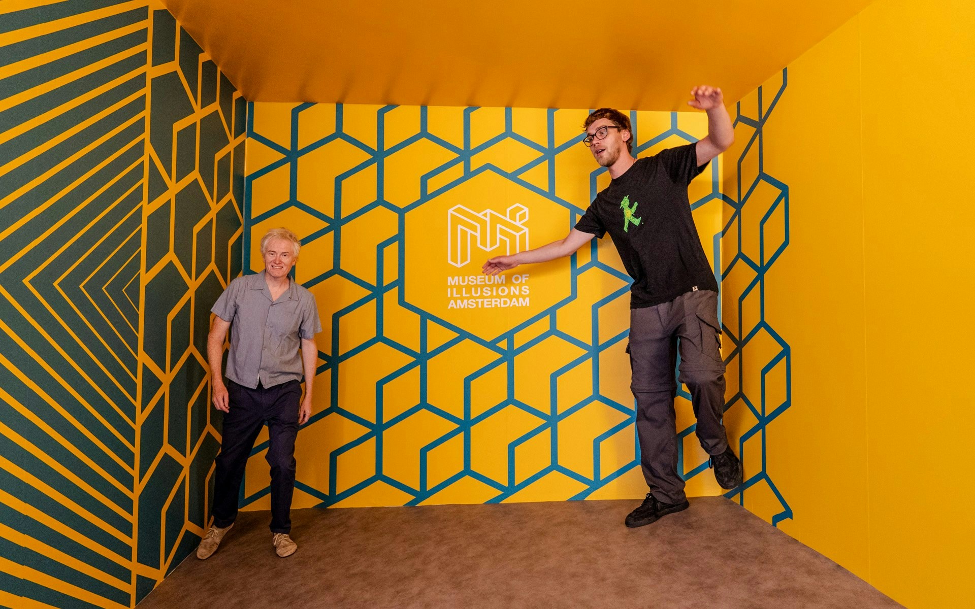 Guests interacting with optical illusions at the Museum of Illusions Amsterdam.