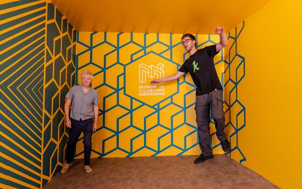 Guests interacting with optical illusions at the Museum of Illusions Amsterdam.