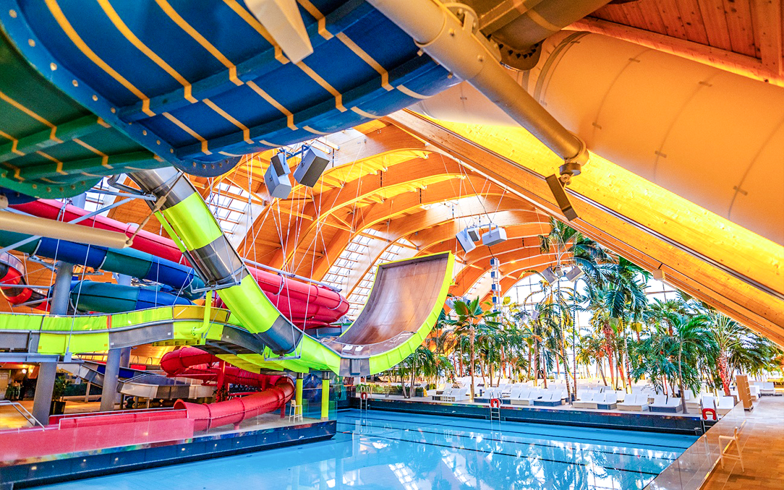 Indoor water slides and pool area at Therme Bucharest, Romania.