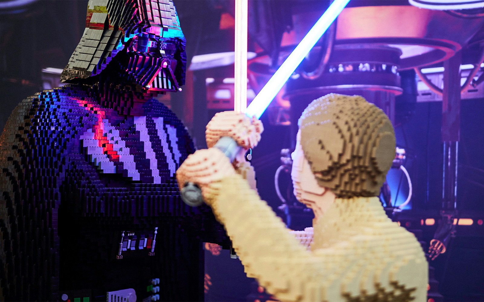 LEGO figures of iconic Star Wars duel with lightsabers at exhibition.